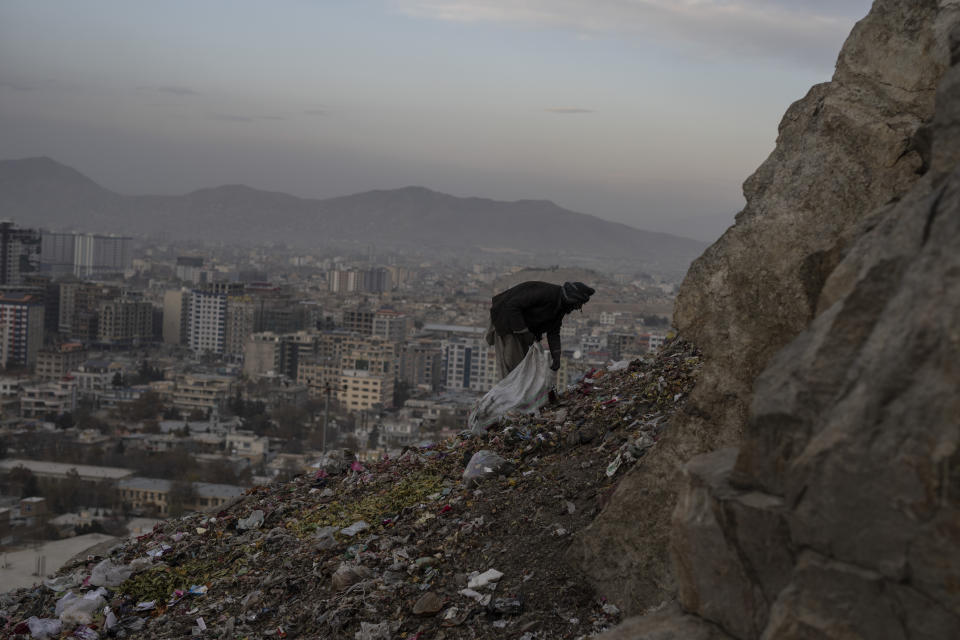 A drug addict salvages scraps of aluminium and plastic to sell, in Kabul, Afghanistan, on Wednesday, Nov. 17, 2021. (AP Photo/ Petros Giannakouris)