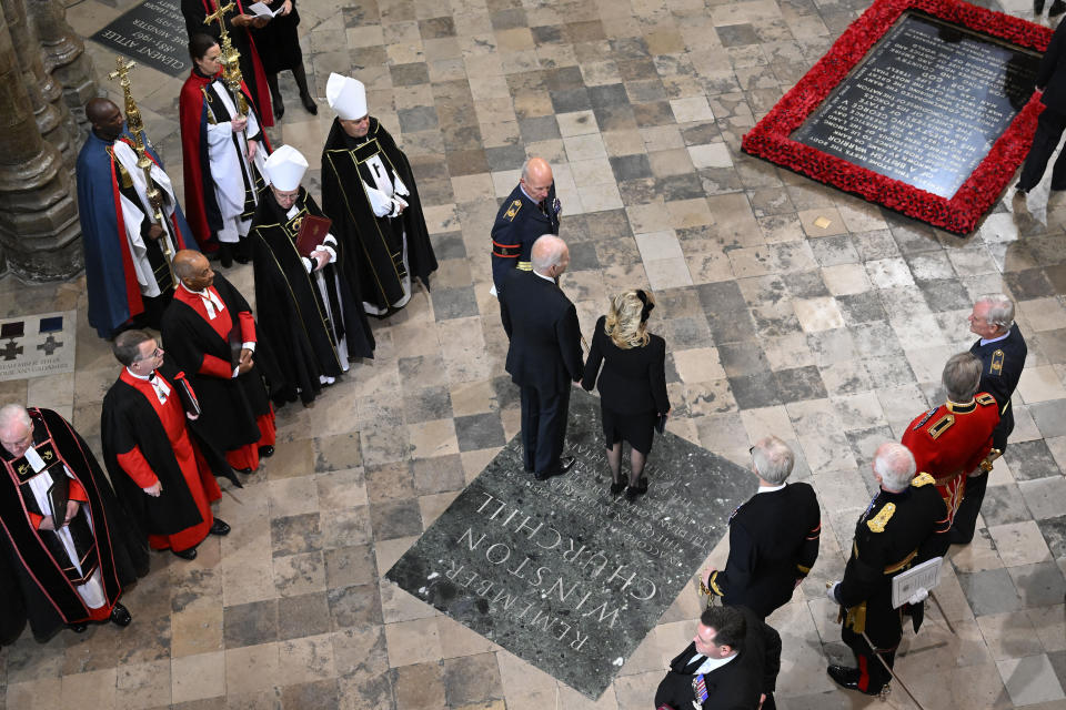 U.S. President, Joe Biden and First Lady Jill Biden, centre, arrive in Westminster Abbey ahead of The State Funeral of Britain's Queen Elizabeth II, in London Monday Sept. 19, 2022. The Queen, who died aged 96 on Sept. 8, will be buried at Windsor alongside her late husband, Prince Philip, who died last year. (Gareth Cattermole/Pool Photo via AP)