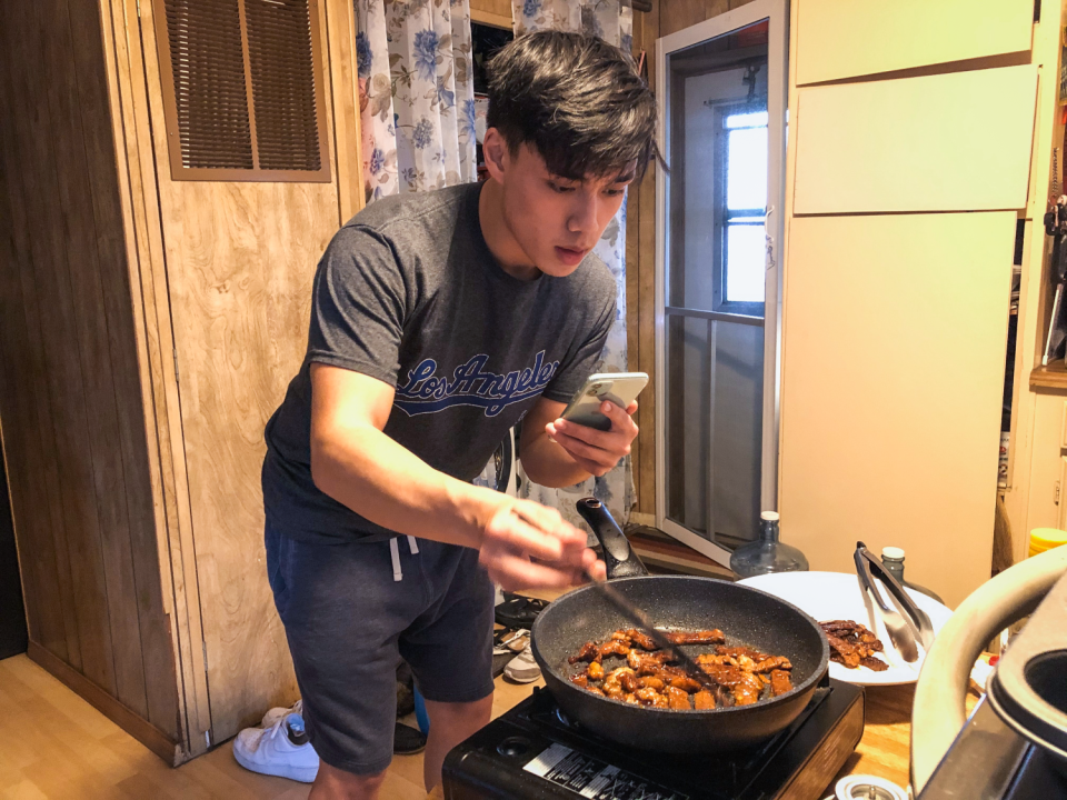 Newton Nguyen cooking Korean beef bulgolgi for a video.