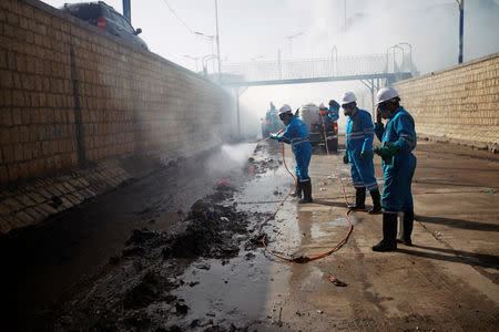 Workers spray pesticides during an anti-cholera campaign in Sanaa, Yemen March 21, 2019. Picture taken March 21, 2019. REUTERS/Mohamed al-Sayaghi