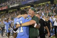 Tulane head coach Willie Fritz celebrates his team's victory over Central Florida with Tulane safety Larry Brooks (31) at the end of the American Athletic Conference championship NCAA college football game in New Orleans, Saturday, Dec. 3, 2022. (AP Photo/Matthew Hinton)