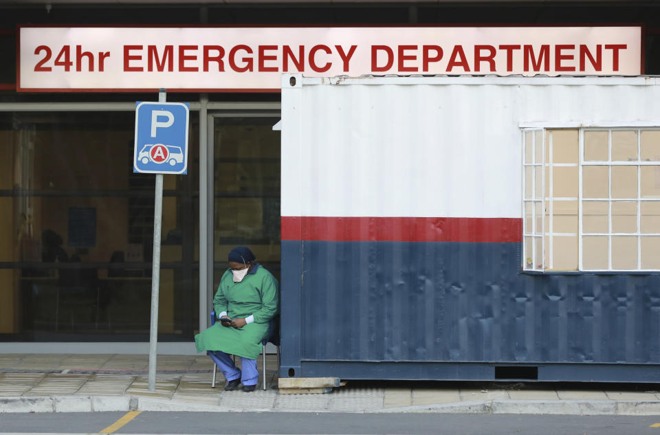 FILE — In this Wednesday June 17, 2020, file photo a health worker in personal protective gear takes a break at the Netcare Christiaan Barnard Memorial Hospital in Cape Town, South Africa. South Africa's Health Minister Zwelini Mkhize said, Sunday, June 18, 2020, that the country's current surge of COVID-19 cases is expected to dramatically increase in the coming weeks and press the country's hospitals to the limit. (AP Photo/Nardus Engelbrecht/File)