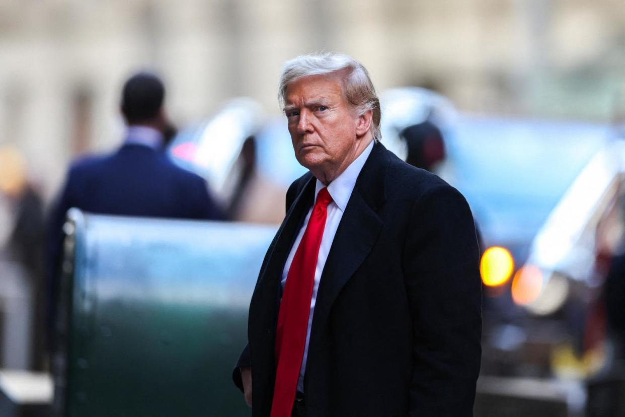 PHOTO: Former US President Donald Trump arrives at 40 Wall Street after his court hearing to determine the date of his trial for allegedly covering up hush money payments linked to extramarital affairs in New York City on March 25, 2024.  (Charly Triballeau/AFP via Getty Images)
