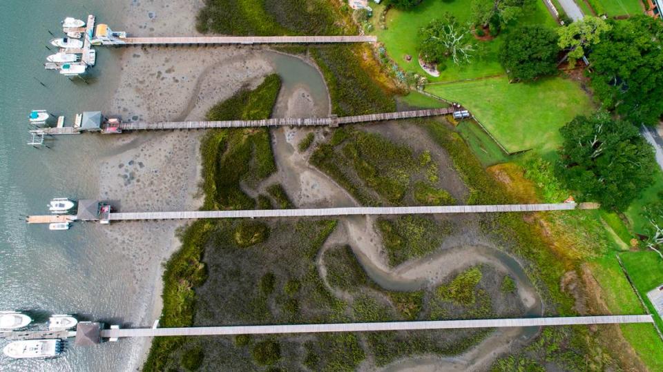 A drone photograph shows residential docks spanning a salt marsh in Wrightsville Beach, Wednesday, Aug 18, 2021. Salt marshes in North Carolina are being pushed back by rising sea waters, but aren’t always able to retreat due to coastal development, leaving them to shrink.