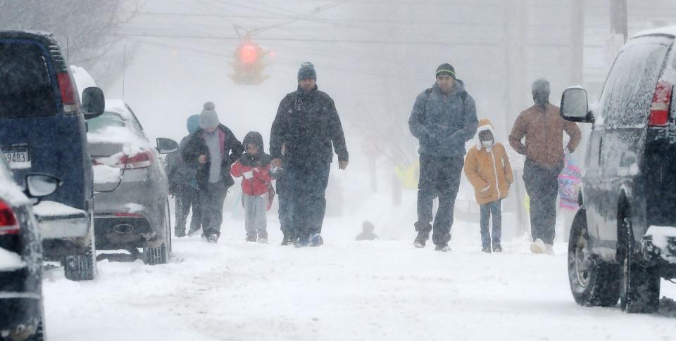 Parents and children walk north on German Street after school in this February 2022 file photo. Wind chills are expected to drop below zero early Monday morning, raising the risks of frostbite and hypothermia.