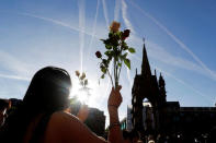 A woman holds flowers as she takes part in a vigil for the victims of an attack on concert goers at Manchester Arena, in central Manchester, Britain May 23, 2017. REUTERS/Darren Staples