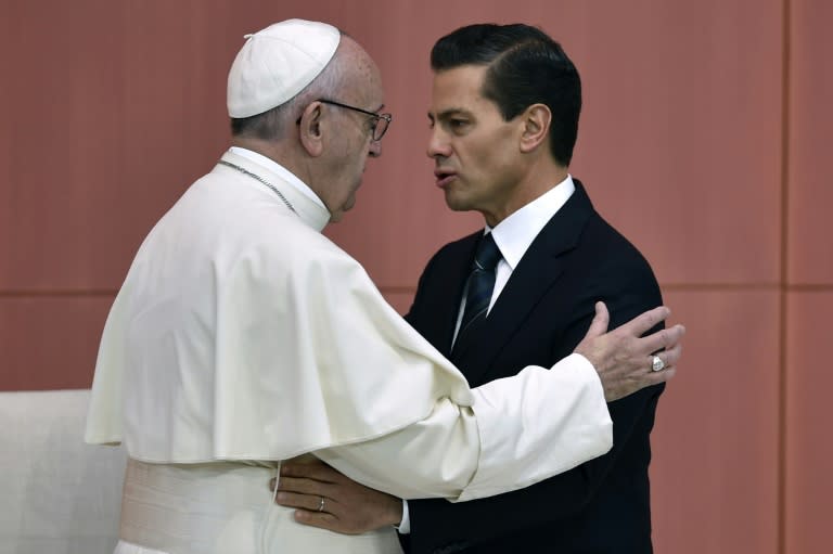 Pope Francis hugs Mexico's President Enrique Pena Nieto (R) after addressing the audience at the National Palace on February 13, 2016 in Mexico City