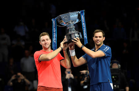 Tennis - ATP Finals - The O2, London, Britain - November 18, 2018 Mike Bryan and Jack Sock of the U.S. celebrate with a trophy after winning the doubles final Action Images via Reuters/Tony O'Brien