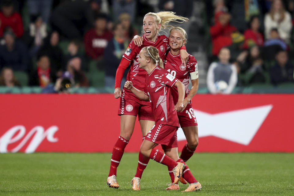 Denmark's Amalie Vangsgaard celebrates with Pernille Harder, right, and Josefine Hasbo, foreground,after scoring the opening goal during the Women's World Cup Group D soccer match between Denmark and China at Perth Rectangular Stadium, in Perth, Australia, Saturday, July 22, 2023. (AP Photo/Gary Day)