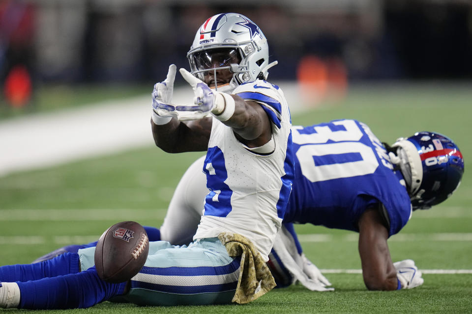 Dallas Cowboys wide receiver CeeDee Lamb, left, gestures in front of New York Giants cornerback Darnay Holmes (30) after making a catch for a first down in the first half of an NFL football game, Sunday, Nov. 12, 2023, in Arlington, Texas. (AP Photo/Julio Cortez)