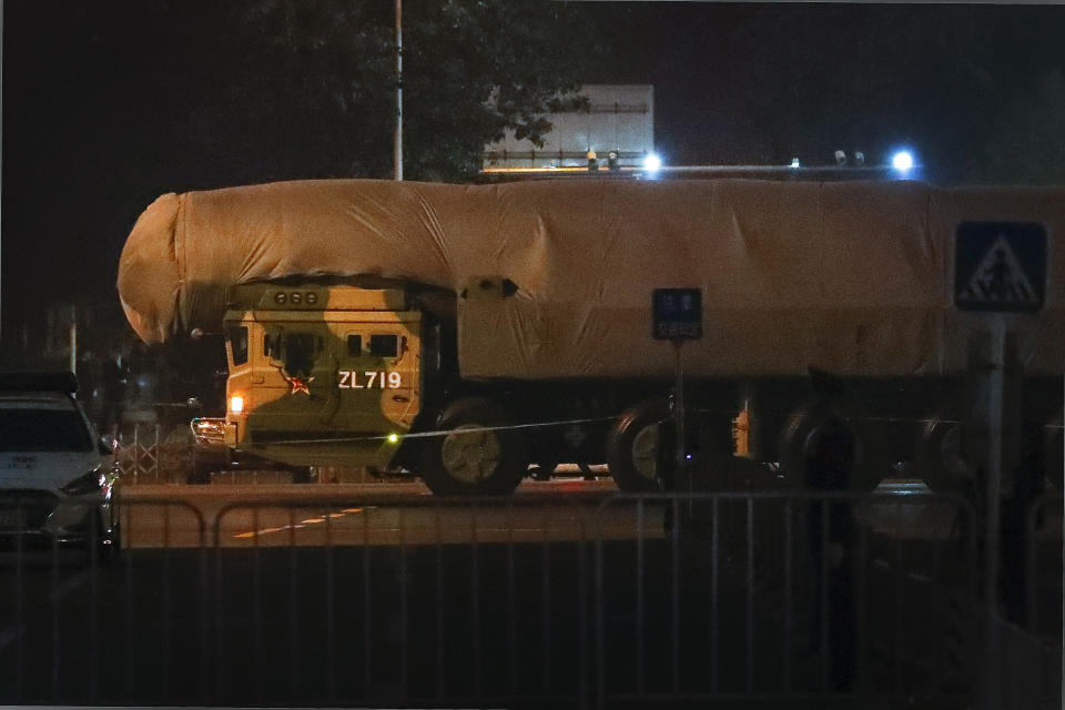 In this Saturday, Sept. 21, 2019, photo, a Chinese military vehicle carrying a covered-up ballistic missile passes along the Jianguomenwai Avenue during a rehearsal for the 70th anniversary of Communist China, in Beijing. A parade Tuesday, Oct. 1 by China’s secretive military will offer a rare look at its rapidly developing arsenal, including possibly a nuclear-armed missile that could reach the United States in 30 minutes, as Beijing gets closer to matching Washington and other powers in weapons technology. (AP Photo/Andy Wong)