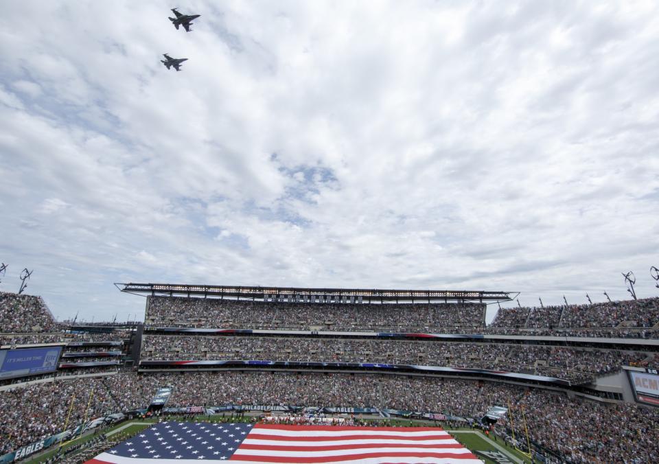 <p>A fly over the field as the American Flag is held during the National Anthem before an NFL football game between the Philadelphia Eagles and the Cleveland Browns, Sunday, Sept. 11, 2016, in Philadelphia. (AP Photo/Chris Szagola) </p>