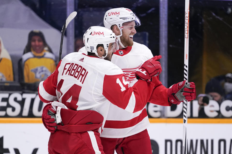 Detroit Red Wings center Robby Fabbri (14) celebrates with Anthony Mantha (39) after Fabbri scored a goal against the Nashville Predators in the first period of an NHL hockey game Saturday, Feb. 13, 2021, in Nashville, Tenn. (AP Photo/Mark Humphrey)