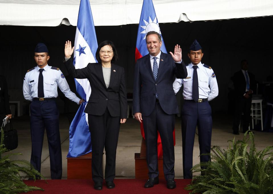 Taiwan's President Tsai Ing-wen, left, and First Vice President of Honduras Ricardo Alvarez, wave during a welcome ceremony after Tsai's arrival at Soto Cano Air Base outside Comayagua, Honduras, Sunday, Jan. 8, 2017. The Taiwanese leader will meet with Honduran President Juan Orlando Hernandez on Monday, as part of a weeklong state tour to reinforce Taiwanese relations with Honduras, Guatemala, El Salvador, and Nicaragua. (AP Photo/Fernando Antonio)