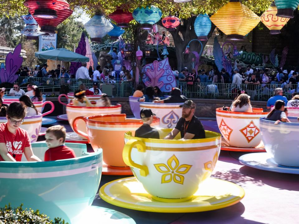 shot of people riding the teacup ride at disneyland