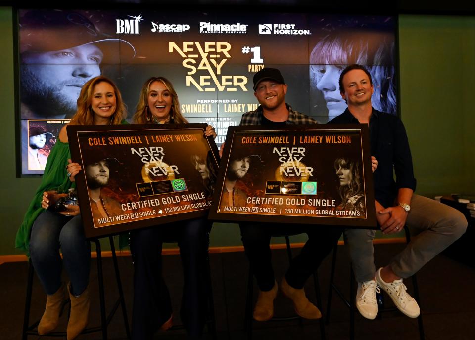 Cole Swindell and Lainey Wilson  celebrate at the “Never Say Never” No. 1 party at BMI on  July 13 in Nashville. Jessi Alexander, Chase McGill and Swindell wrote the song, which was performed by Swindell and Wilson