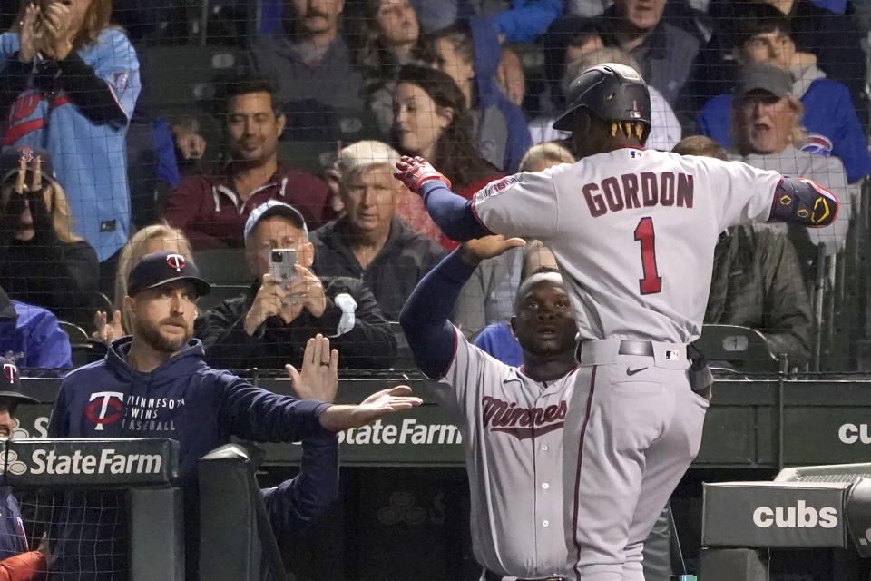 Minnesota Twins' Nick Gordon (1) celebrates his two-run home run off Chicago Cubs starting pitcher Alec Mills, with manager Rocco Baldelli, left, and Miguel Sano as he enters the dugout during the fourth inning of a baseball game Tuesday, Sept. 21, 2021, in Chicago. (AP Photo/Charles Rex Arbogast)