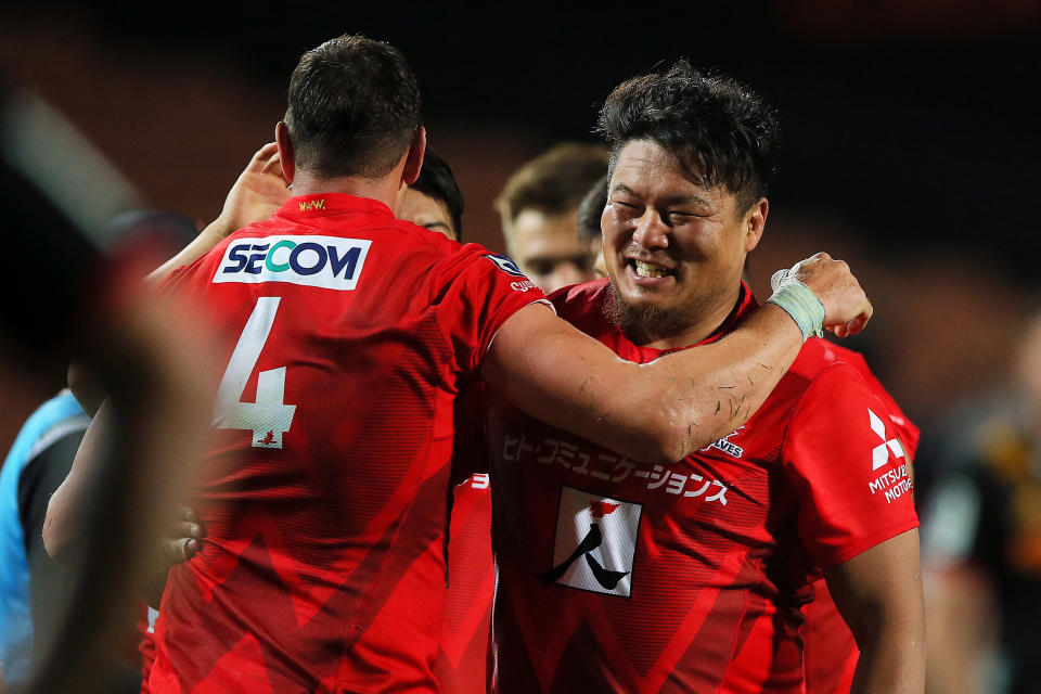 Sunwolves prop Hiroshi Yamashita, right, and Sunwolves lock Luke Thompson celebrate their victory in the Super Rugby match between the Sunwolves and the Chiefs in Hamilton, New Zealand, Saturday, March 2, 2019. (AP Photo/Bruce Lim)