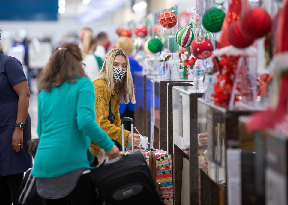 Travelers check in with American Airlines at Palm Beach International Airport of the holidays.