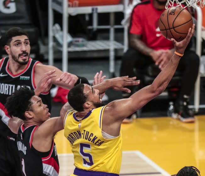 Los Angeles, CA, Monday, December 28, 2020 - Los Angeles Lakers guard Talen Horton-Tucker (5) slices past Portland Trail Blazers guard Anfernee Simons (1) for a first half layup at Staples Center. (Robert Gauthier/ Los Angeles Times)