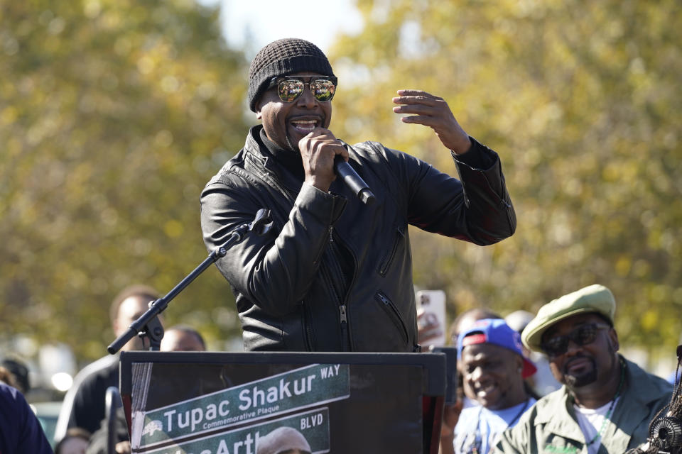 MC Hammer speaks during a street renaming ceremony for Tupac Shakur as Fred Hampton Jr., right, listens in Oakland, Calif., Friday, Nov. 3, 2023. A stretch of street in Oakland was renamed for Shakur, 27 years after the killing of the hip-hop luminary. A section of Macarthur Boulevard near where he lived in the 1990s is now Tupac Shakur Way, after a ceremony that included his family members and Oakland native MC Hammer. (AP Photo/Eric Risberg)