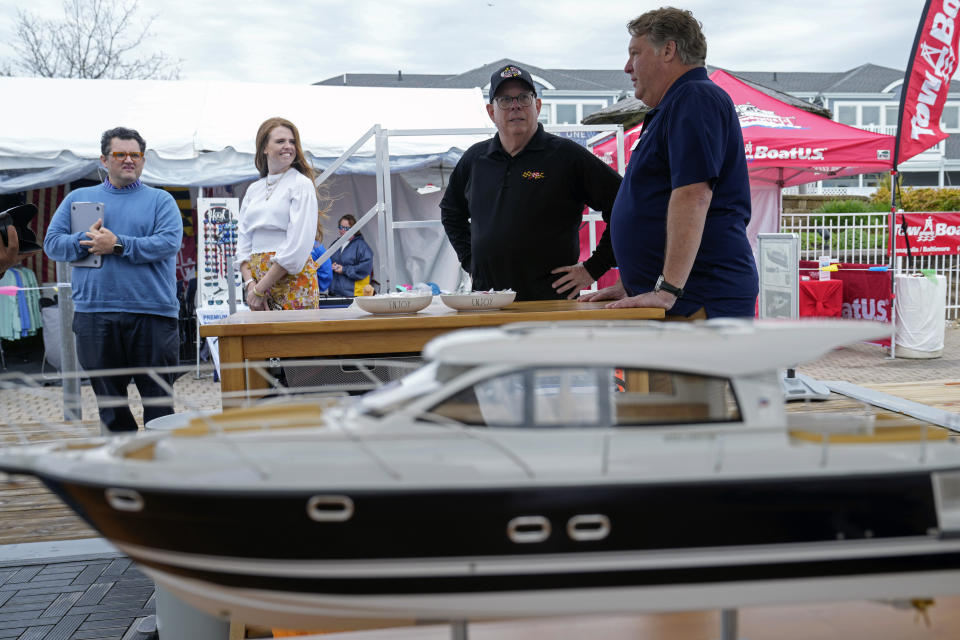 Former Maryland Gov. Larry Hogan, second from right, talks with Bill O'Malley, right, of Annapolis, Md., during a visit to the Bridge Boat Show in Stevensville, Md., Friday, April 12, 2024, as he campaigns for the U.S. Senate. (AP Photo/Susan Walsh)