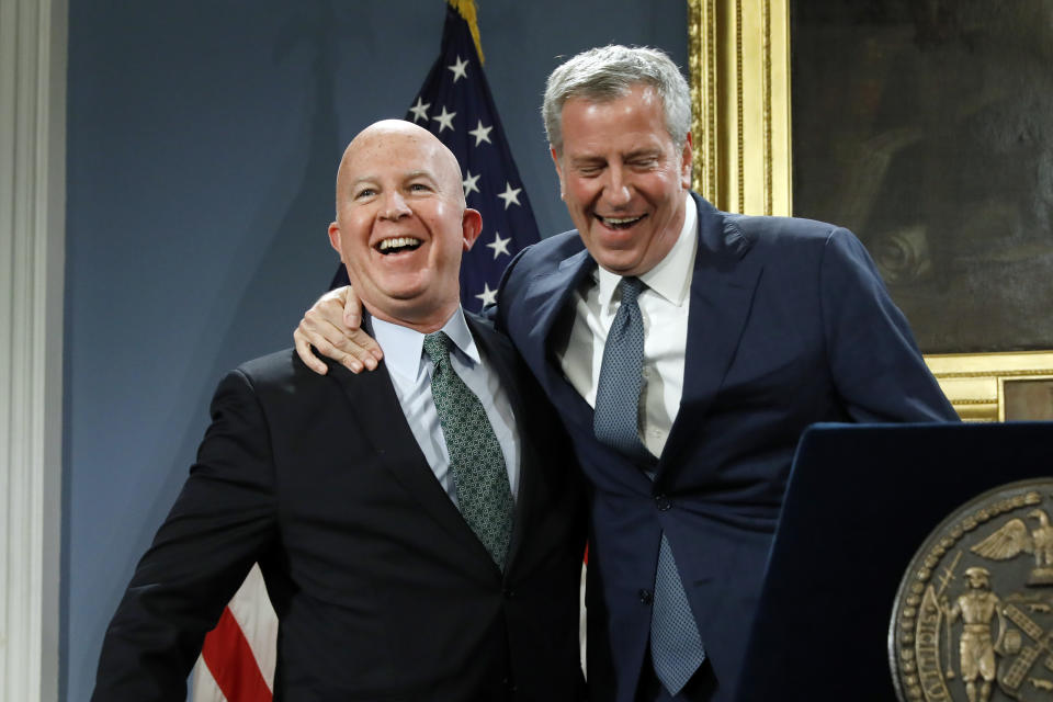New York City Police Commissioner James O'Neill, left, is embraced by New York Mayor Bill de Blasio at New York's City Hall, Monday, Nov. 4, 2019. New York City's police commissioner is retiring after three years in charge of the nation's largest police department, Mayor Bill de Blasio said Monday. (AP Photo/Richard Drew)