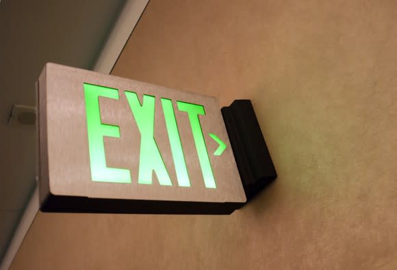 An illuminated exit sign above a door.