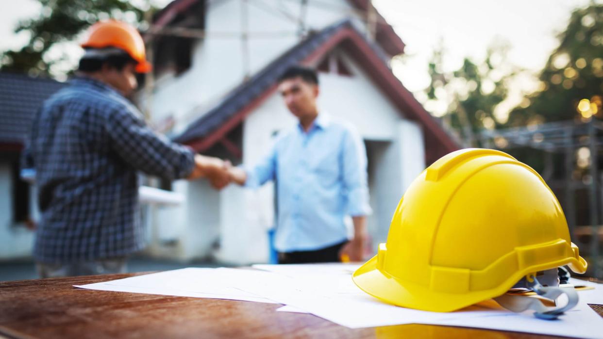 Shaking hands of partnership agreement between structural engineers and contractors to build houses.