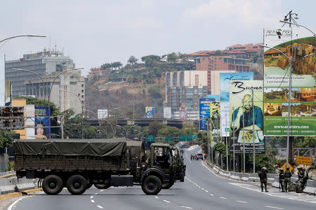 Military trucks partially block a highway in Caracas, Venezuela April 30, 2019. REUTERS/Carlos Garcia Rawlins