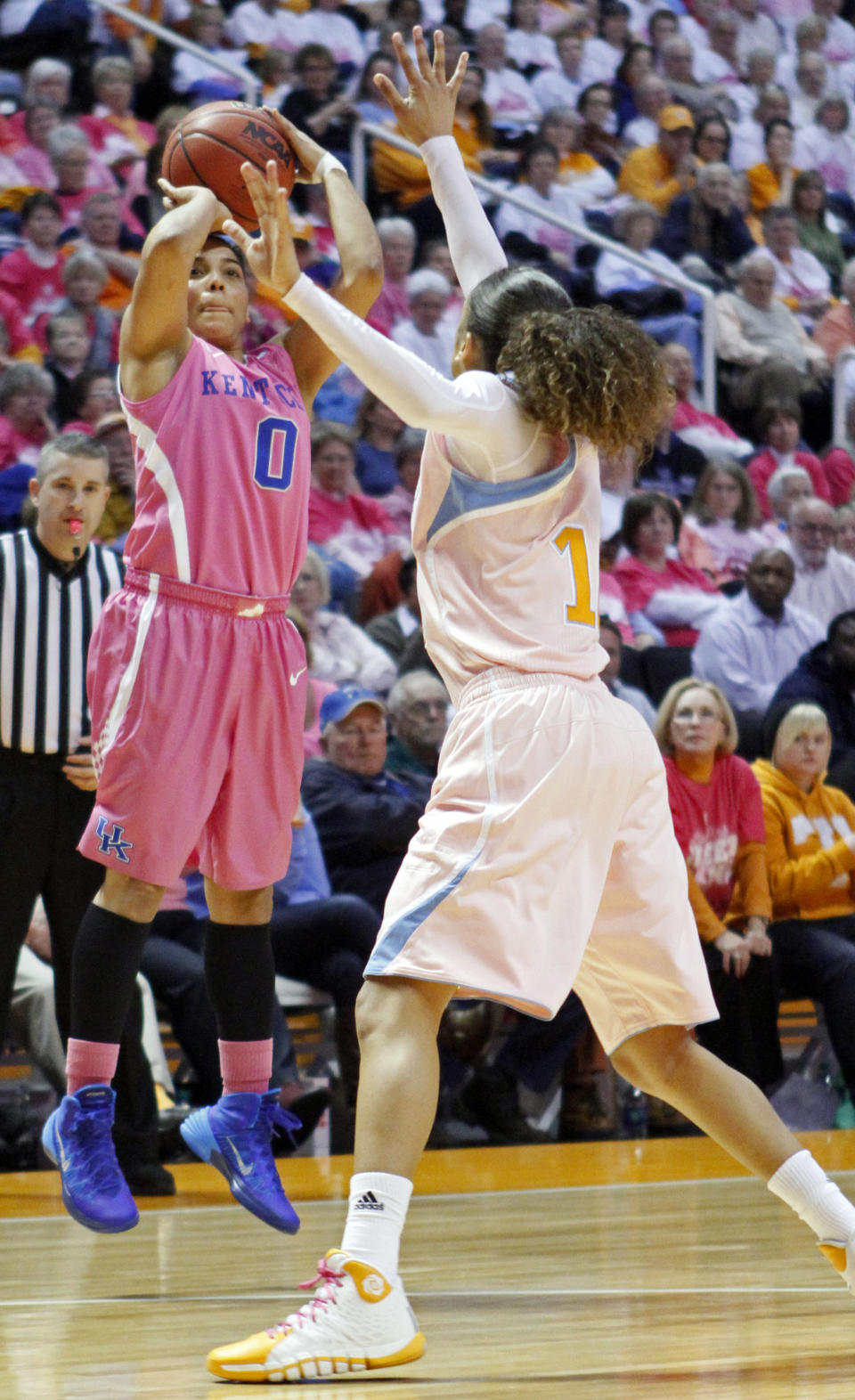 Kentucky guard Jennifer O'Neill (0) shoots over Tennessee guard Meighan Simmons in the second half of an NCAA college basketball game on Sunday, Feb. 16, 2014, in Knoxville, Tenn. Kentucky won 75-71. (AP Photo/Wade Payne)