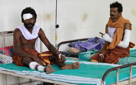 Men who were injured in a fire at Puttingal Devi temple, rest in beds inside a hospital ward in Kollam in the southern state of Kerala, India, April 11, 2016. REUTERS/Sivaram V