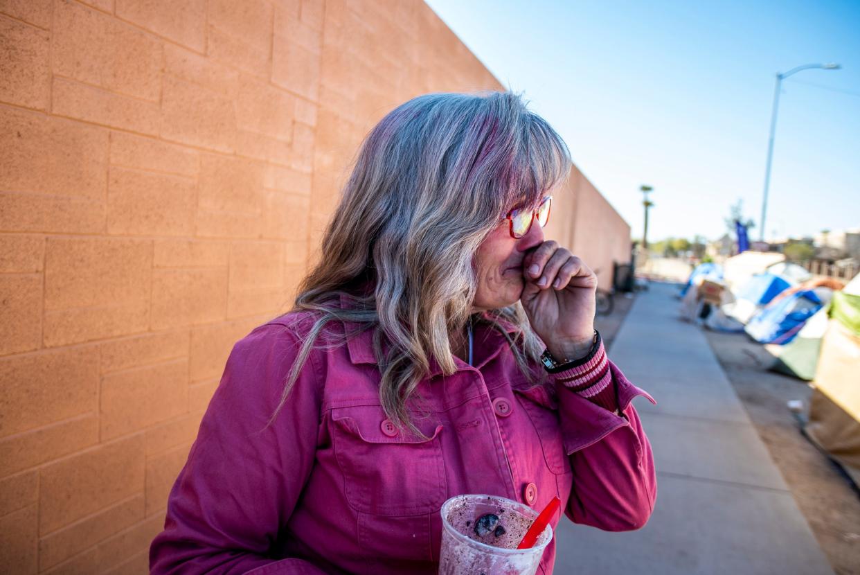 Darlene Carchedi gets emotional after CASS employees helped warn her and other people experiencing homelessness of the upcoming cleanup at an encampment of around 400 people near Central Arizona Shelter Services and other services in Phoenix on Tuesday, Feb. 4, 2020.