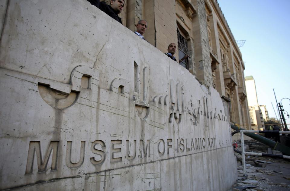 Egyptian security officers stand guard at the entrance of the Museum of Islamic Art after an explosion at the Egyptian police headquarters in downtown Cairo, Friday, Jan. 24, 2014. Egypt's antiquities minister says the car bombing that struck the main police headquarters in Cairo earlier in the day has caused major damage to the nearby Islamic art museum.(AP Photo/Khalil Hamra)