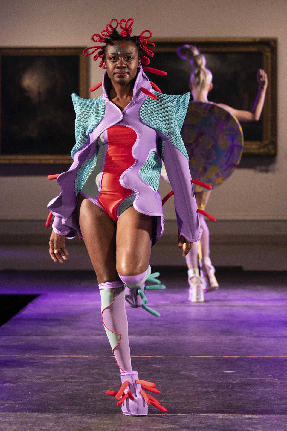 The Claire Fleury collection is modeled during the dapperQ fashion show at the Brooklyn Museum on Thursday Sept. 5, 2019, in New York. (AP Photo/Jeenah Moon)