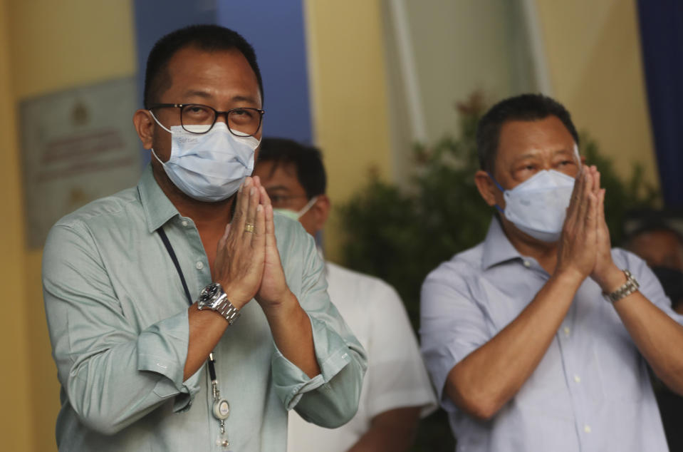 President Director of Sriwijaya Air Jefferson Irwin Jauwena, left, gestures to journalists during a press conference at a hospital in Jakarta, Indonesia, Tuesday, Jan. 12, 2021. Indonesian navy divers were searching through plane debris and seabed mud Tuesday looking for the black boxes of a Sriwijaya Air jet that nosedived into the Java Sea over the weekend with 62 people aboard. (AP Photo/Achmad Ibrahim)