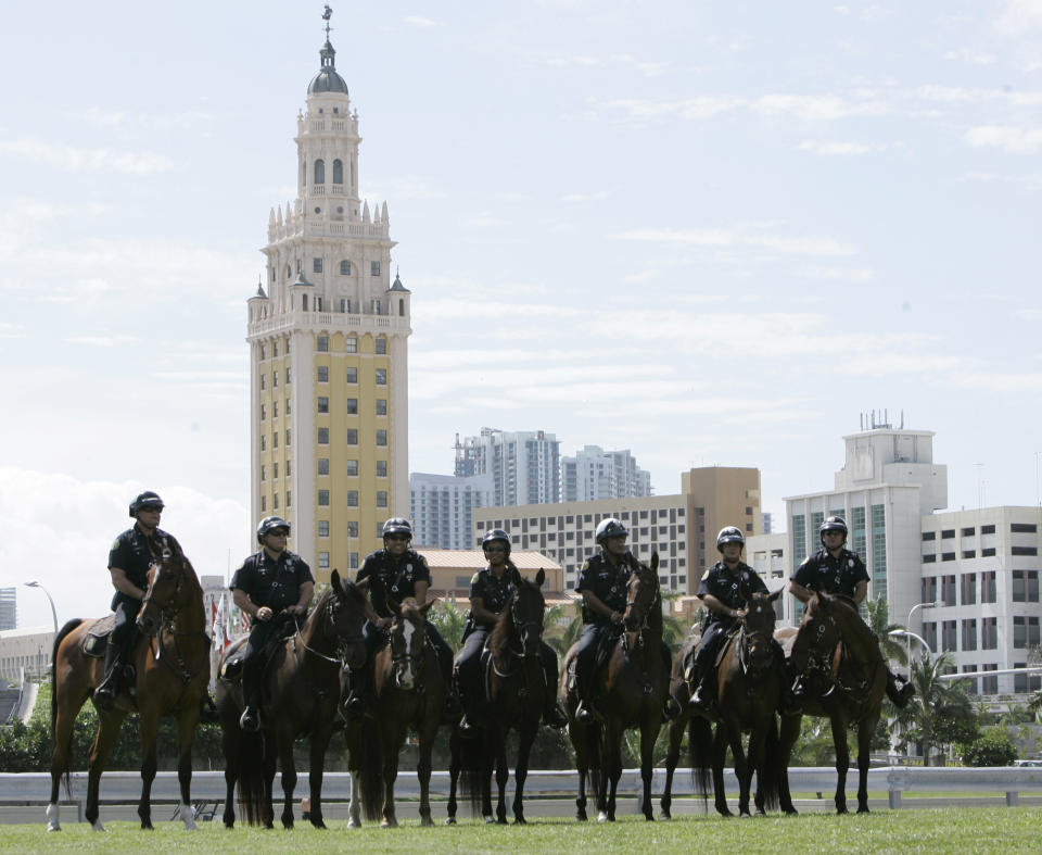 FILE- In this Oct. 21, 2008 file photo, mounted city of Miami police line up in front of the famed Freedom Tower as they wait for a rally with then Democratic presidential candidate, Sen. Barack Obama, D-Ill., at Bicentennial Park in Miami. A preservation group is inviting the public to vote on twenty sites across the country, including the Freedom Tower, that showcase the nation's diversity and the fight for equality as part of a $2 million historic preservation campaign. (AP Photo/Wilfredo Lee, File)