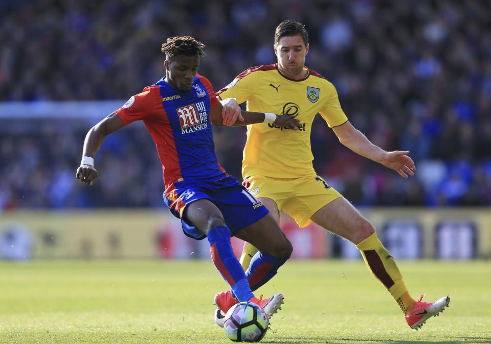 <p>Crystal Palace’s Wilfried Zaha, left, and Burnley’s Stephen Ward battle for the ball </p>