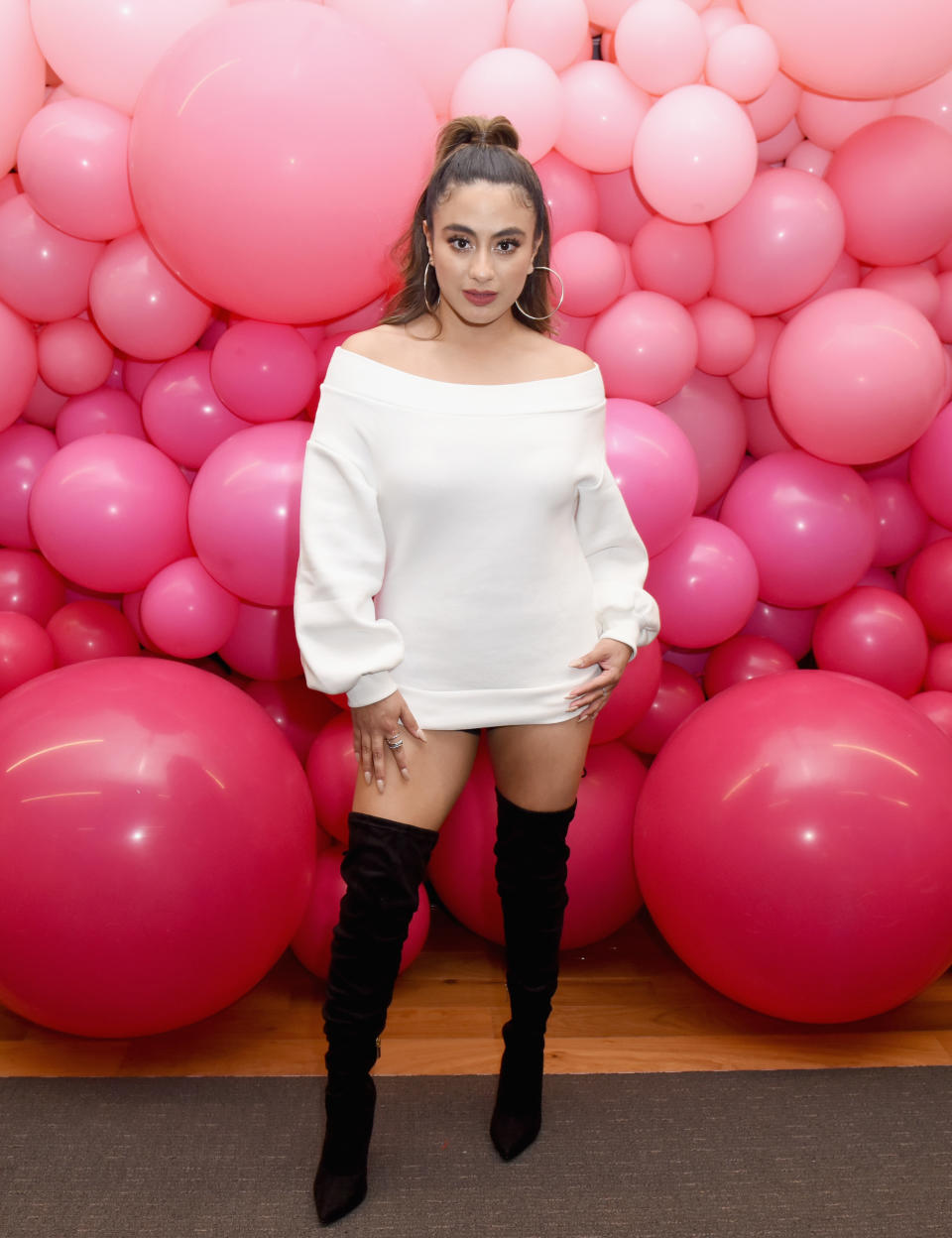 Ally Brooke poses in front of pink balloons