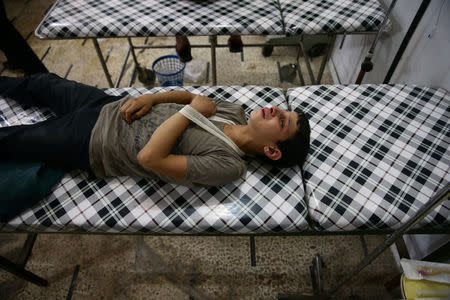 An injured youth reacts inside a field hospital after shelling in the rebel held Douma neighborhood of Damascus, Syria July 21, 2016. REUTERS/Bassam Khabieh