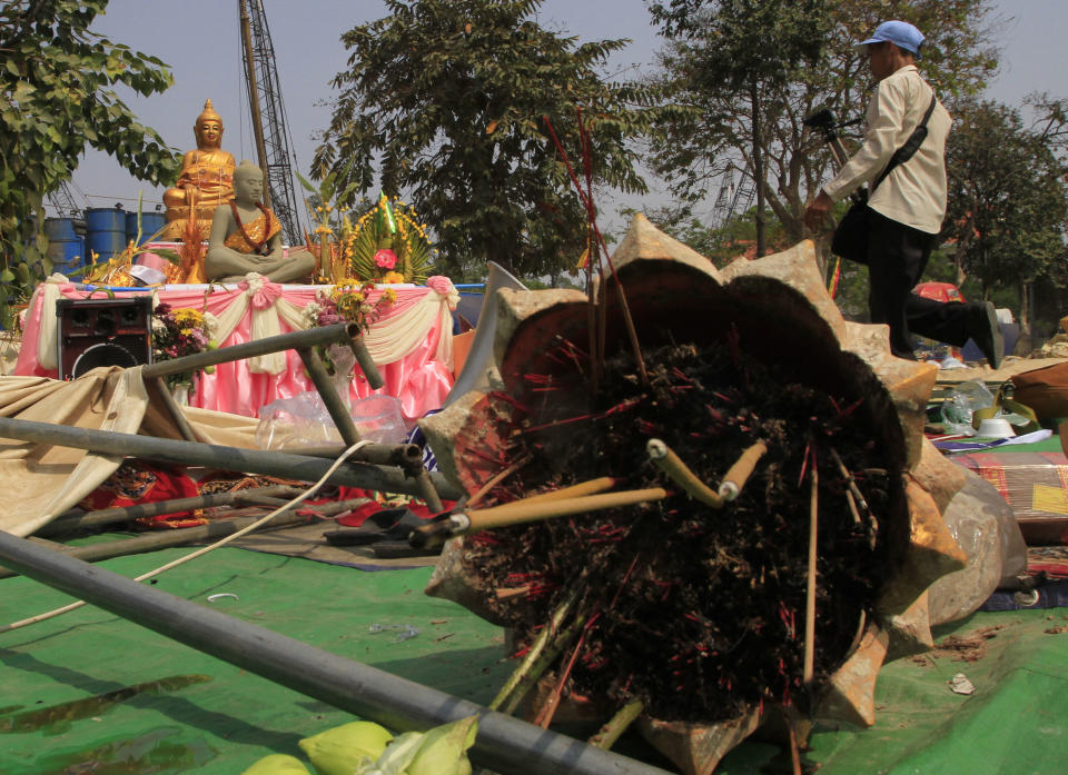 Buddha statues stand in the destroyed area where Cambodian National Rescue Party supporters gather for prayers in their rally at Democracy Square in Phnom Penh, Cambodia, Saturday, Jan. 4, 2014. Cambodian police have pushed out about 1,000 anti-government demonstrators from the park in the capital Phnom Penh, a day after four people were killed in a crackdown on a labor protest. (AP Photo/Heng Sinith)