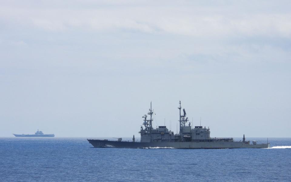 A manned Taiwanese warship keeps an eye on a Chinese aircraft carrier. China would be able to deploy a large amount of naval power rapidly in an invasion attempt, meaning that Taiwanese USVs would need to be resent in large numbers