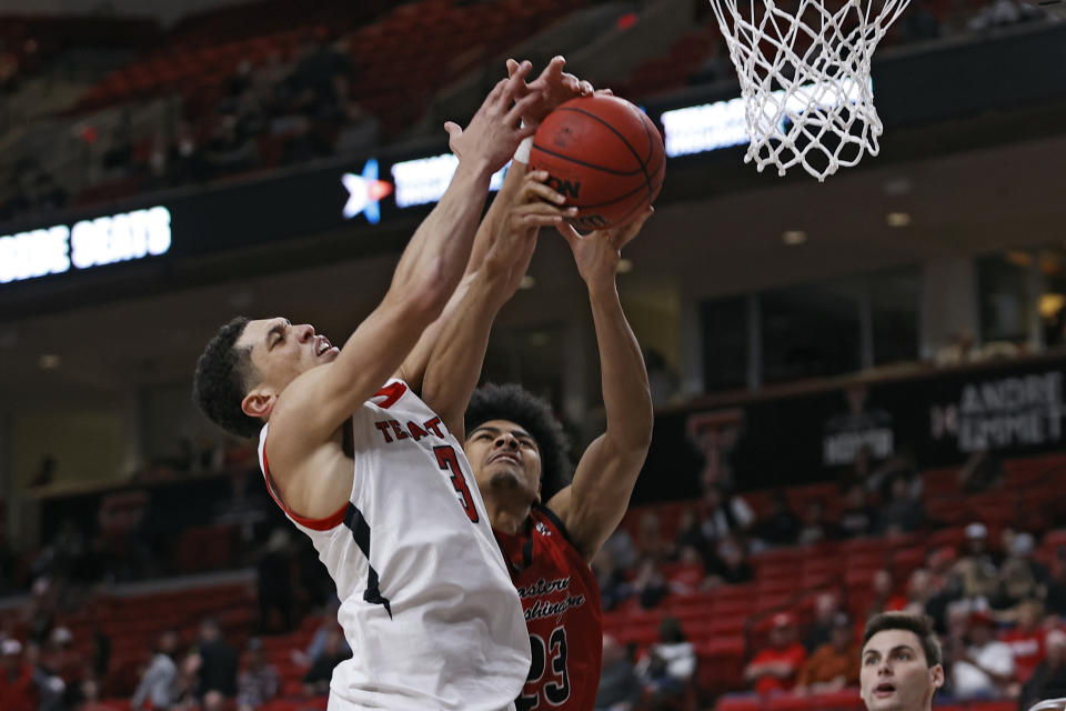 Texas Tech's Clarence Nadolny (3) and Eastern Washington's Michael Folarin (23) try to rebound the ball during the second half of an NCAA college basketball game on Wednesday, Dec. 22, 2021, in Lubbock, Texas. (AP Photo/Brad Tollefson)