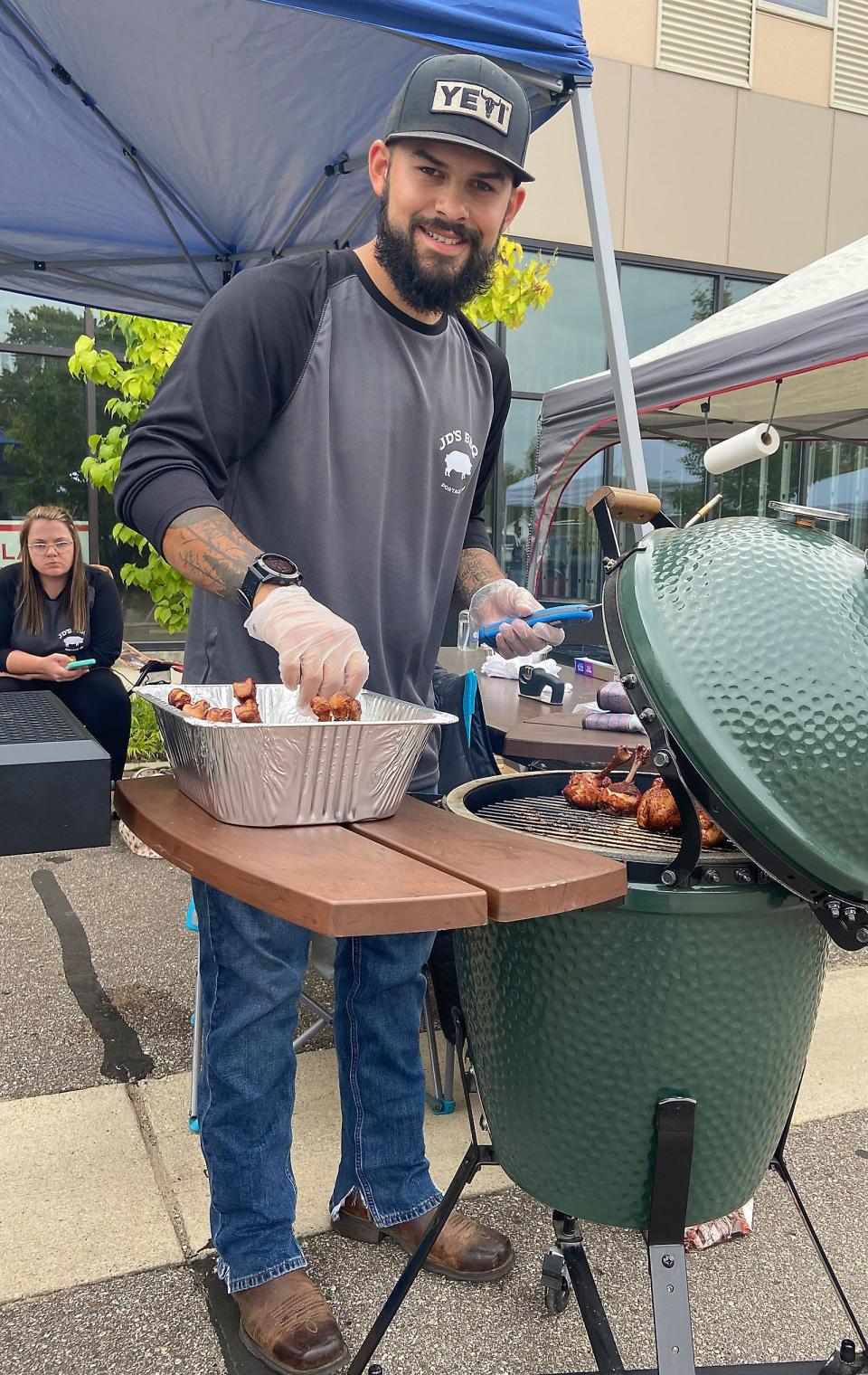 Jake DeKoning of JD's BBQ of Portage tends to his chicken lollipops Oct. 2 at Sturgis Barbecue Fest. It was his first time at the Sturgis festival and only his second competition ever.