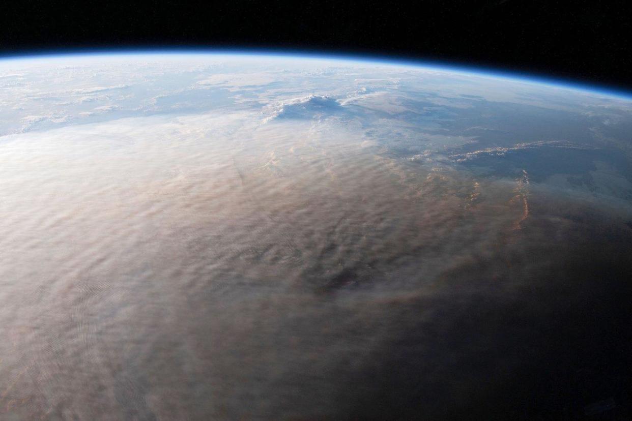 An image from the ISS from Jan. 16, 2022, shows the ash plume from the Hunga Tonga-Hunga Ha'apai volcanic eruption that occurred the day before.  / Credit: NASA