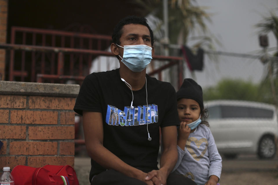 Carlos Enrique Linga Rivera, 27, and his daughter Betty Noemi, 5, talk to The Associated Press while waiting at Our Lady of Guadalupe Catholic Church in McAllen, Texas, on Palm Sunday, March 28, 2021. U.S. authorities are releasing migrant families at the border without notices to appear in immigration court and sometimes, like in the case of Rivera, without any paperwork at all. (AP Photo/Dario Lopez-Mills)