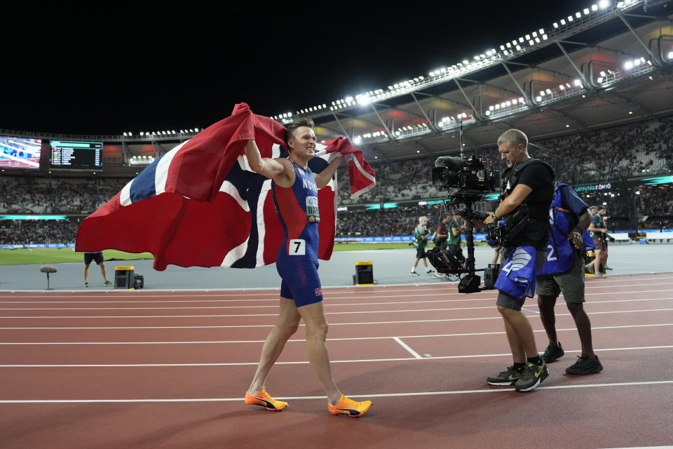 Karsten Warholm, of Norway, celebrates after winning the men's 400-meters final during the World Athletics Championships in Budapest, Hungary, Wednesday, Aug. 23, 2023. (AP Photo/Ashley Landis)