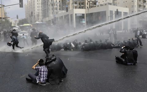 Ultra-Orthodox extremists have blocked roads in protests over the military draft and Jerusalem's gay pride parade - Credit: MENAHEM KAHANA/AFP/Getty Images