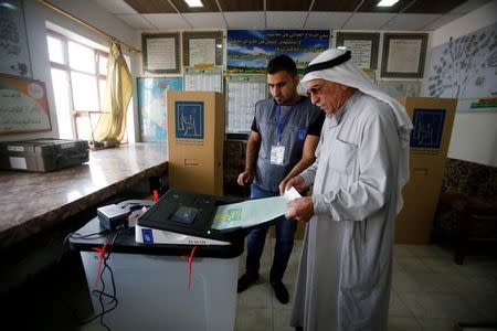 An Iraqi man casts his vote at a polling station during the parliamentary election in Mosul, Iraq May 12, 2018. REUTERS/Khalid al-Mousily