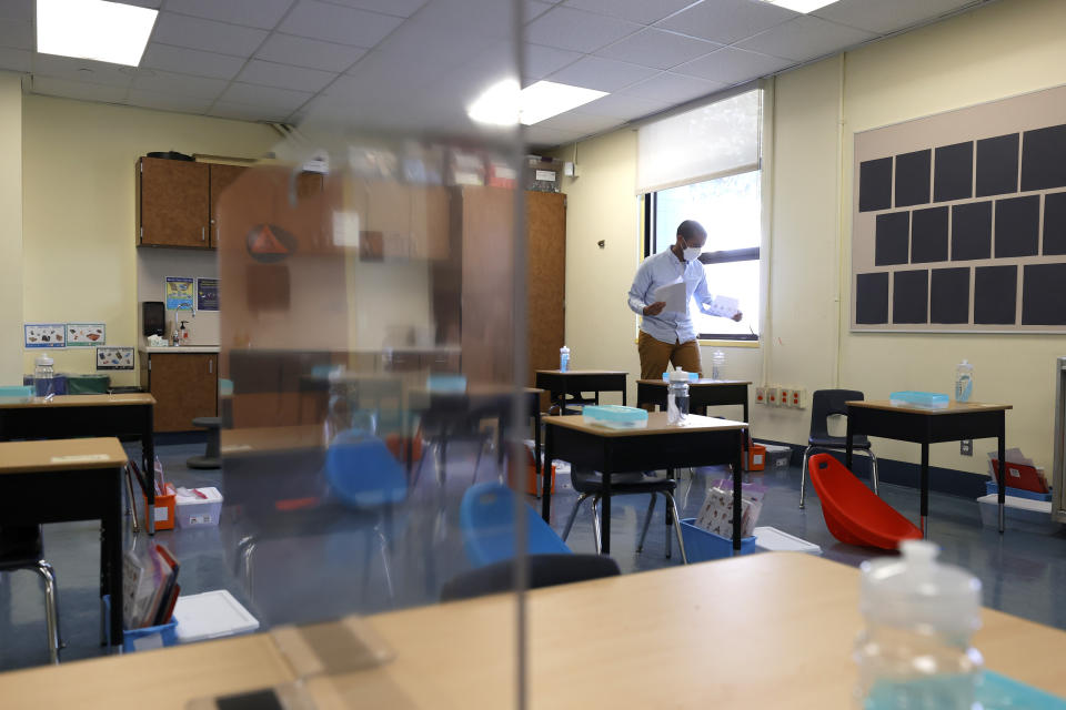 A kindergarten teacher sets up his classroom. 